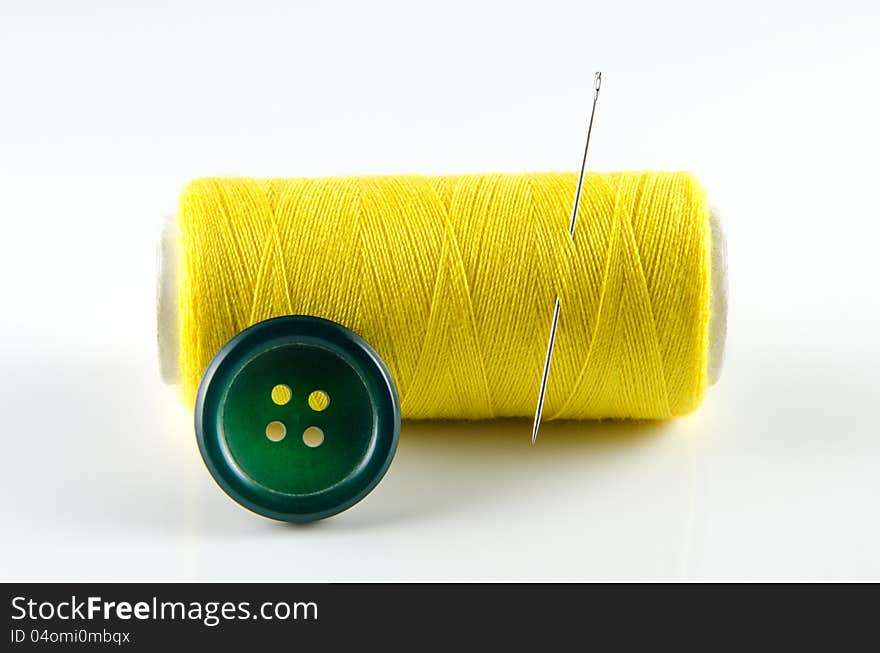 Spool of thread and button