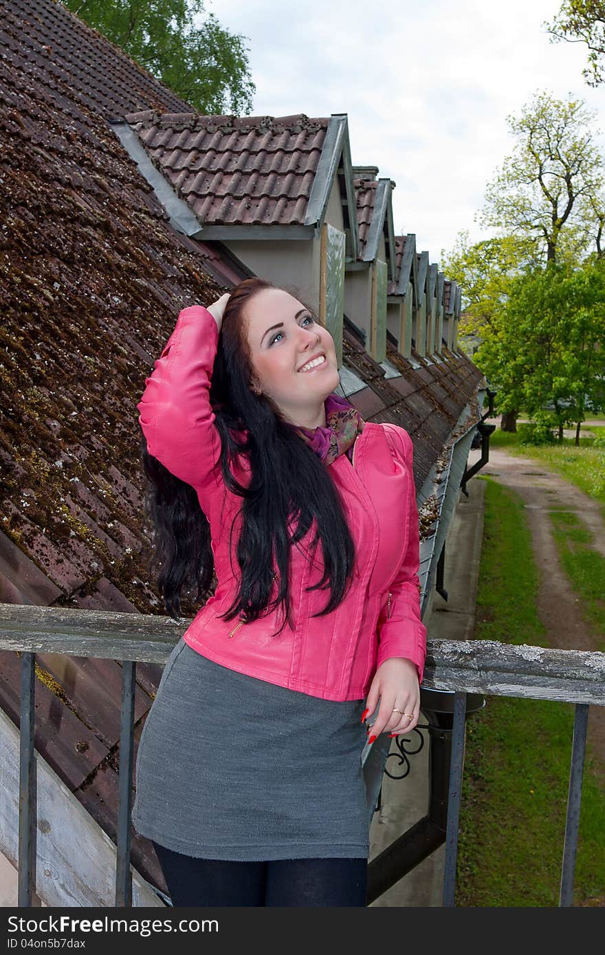 A Girl Standing On The Balcony