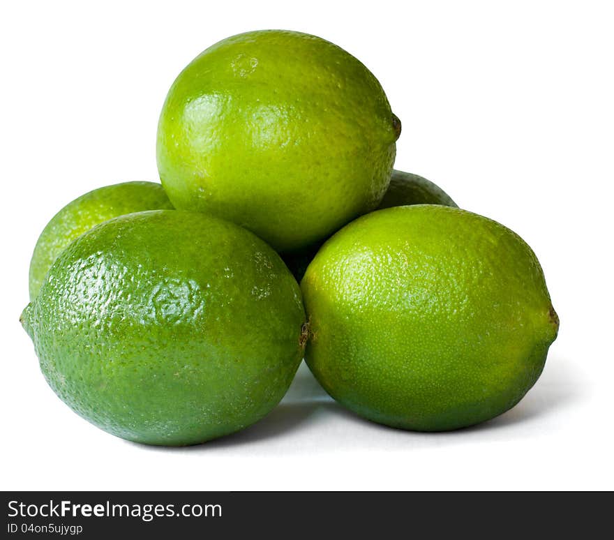 A group of limes arranged in a pyramid formation and isolated on a white background. A group of limes arranged in a pyramid formation and isolated on a white background