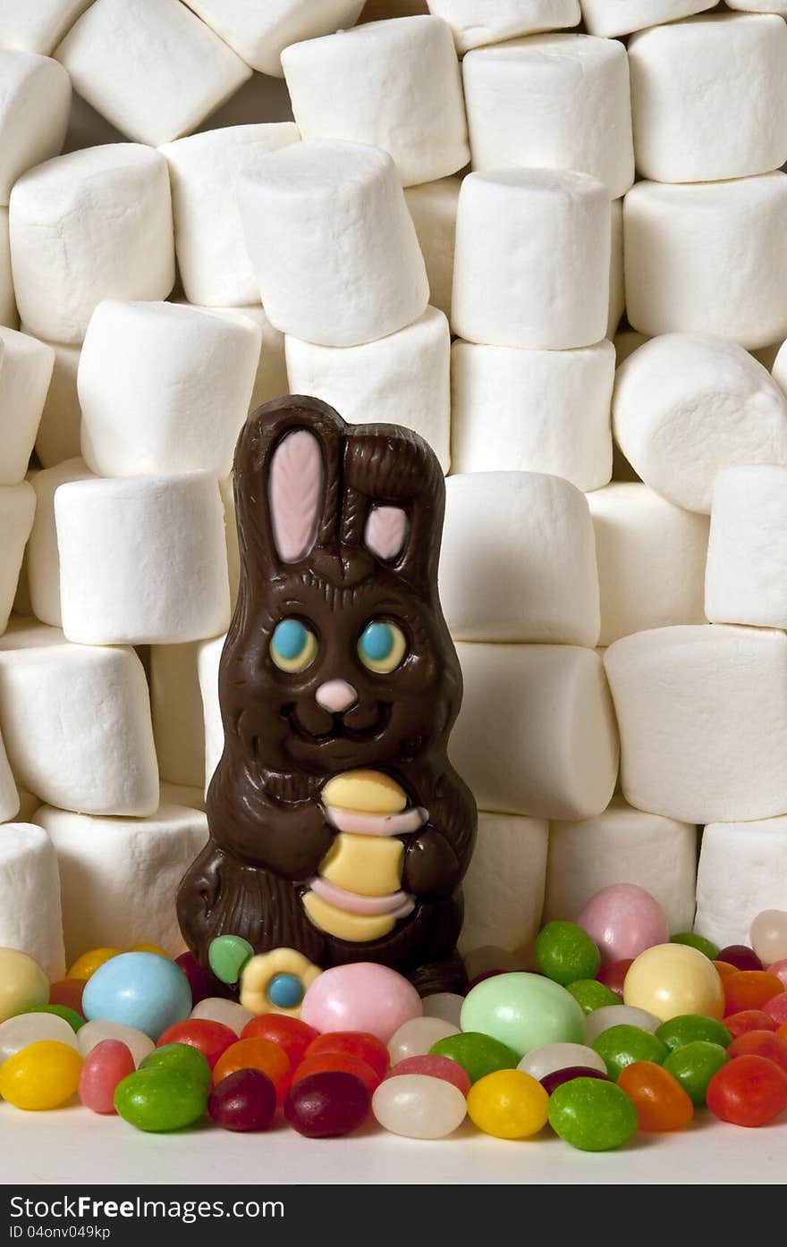Horizontal of chocolate rabbit easter candy and background of marshmallows