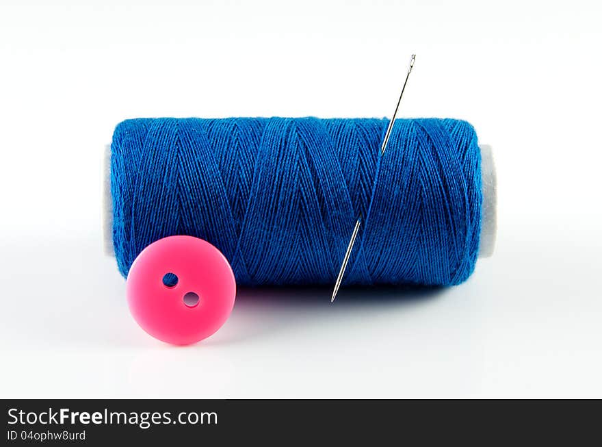 Spool of thread and button