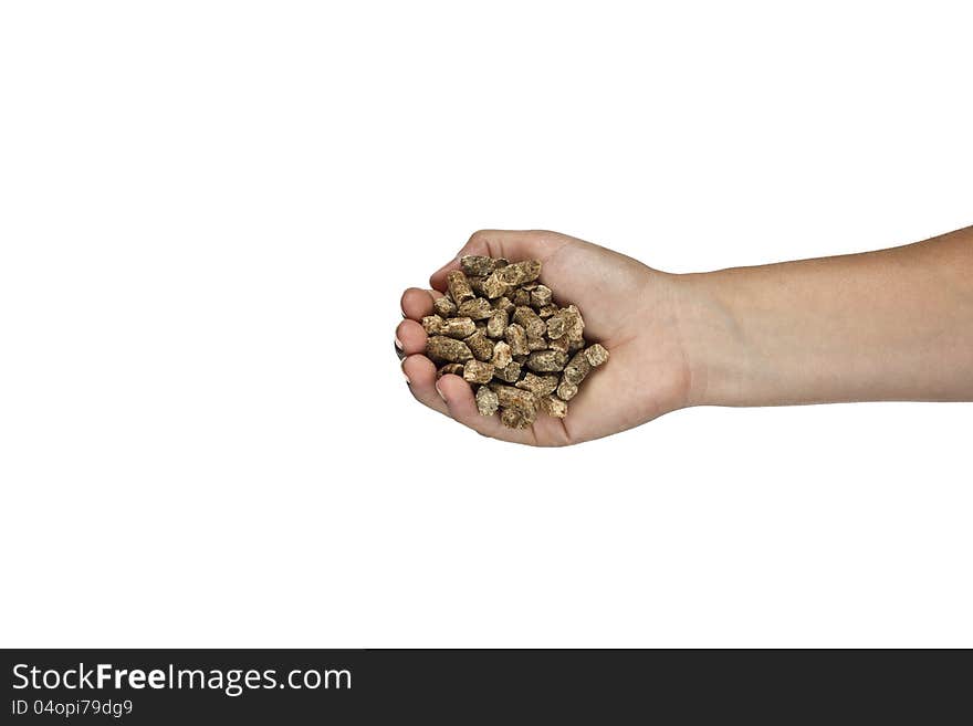 Hand with natural wood pellet on a white background. Hand with natural wood pellet on a white background.