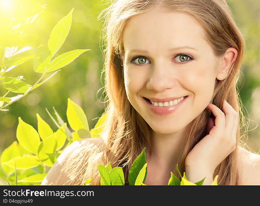 Beauty girl in nature with green leaves