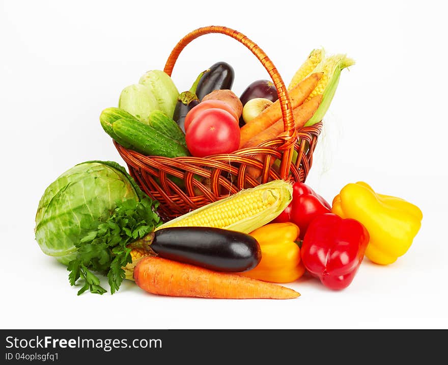 Basket with vegetables on white