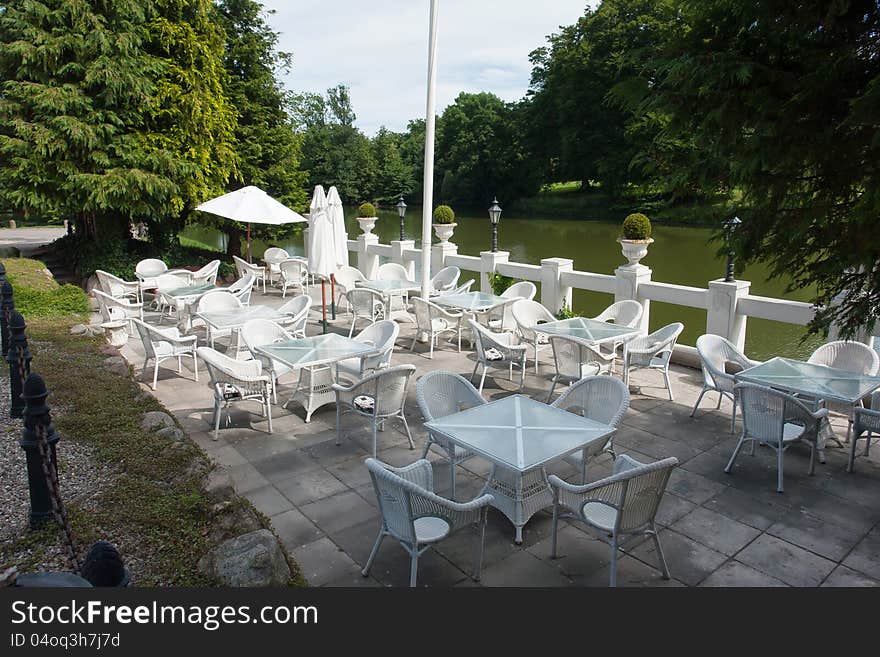 Coffee shop cafe with classical garden furniture by a lake in Denmark. Coffee shop cafe with classical garden furniture by a lake in Denmark