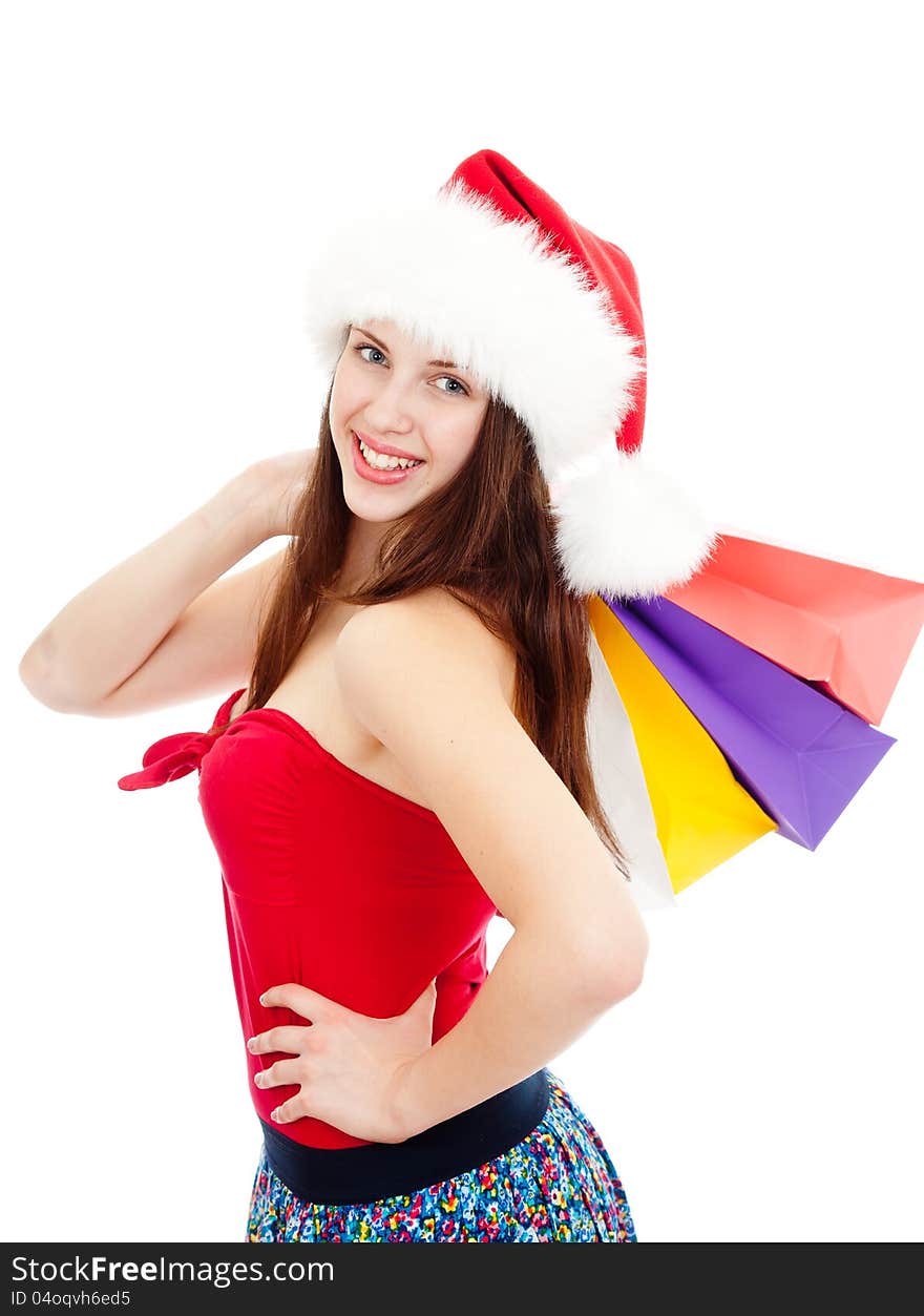 Pretty girl in Christmas hat with colourful bags