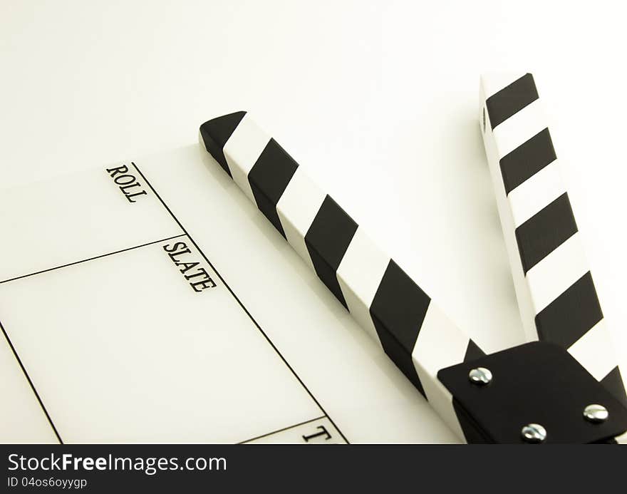 Film clapboard with black stripes on white background