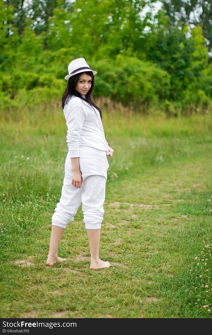 A young pretty brunette posing in a summer setting. A young pretty brunette posing in a summer setting