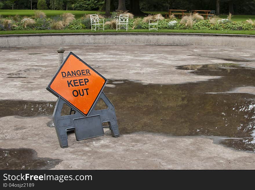 Empty fountain with danger keep out sign. Empty fountain with danger keep out sign