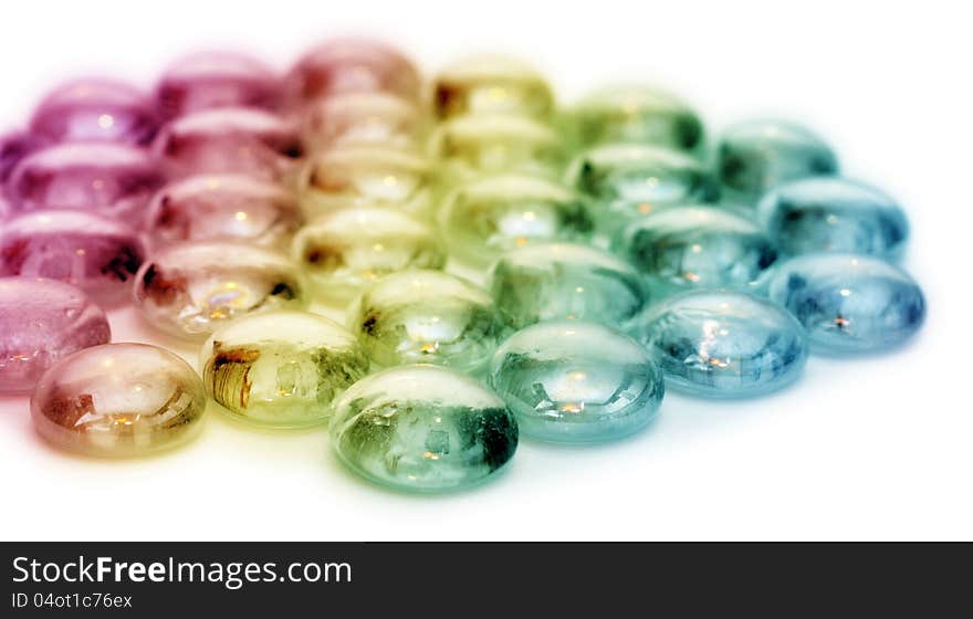 Small colored stones over white background. Small colored stones over white background