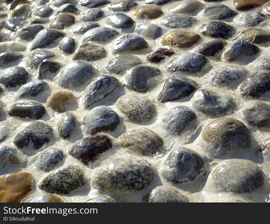 Wet stones pavement forming a texture. Wet stones pavement forming a texture