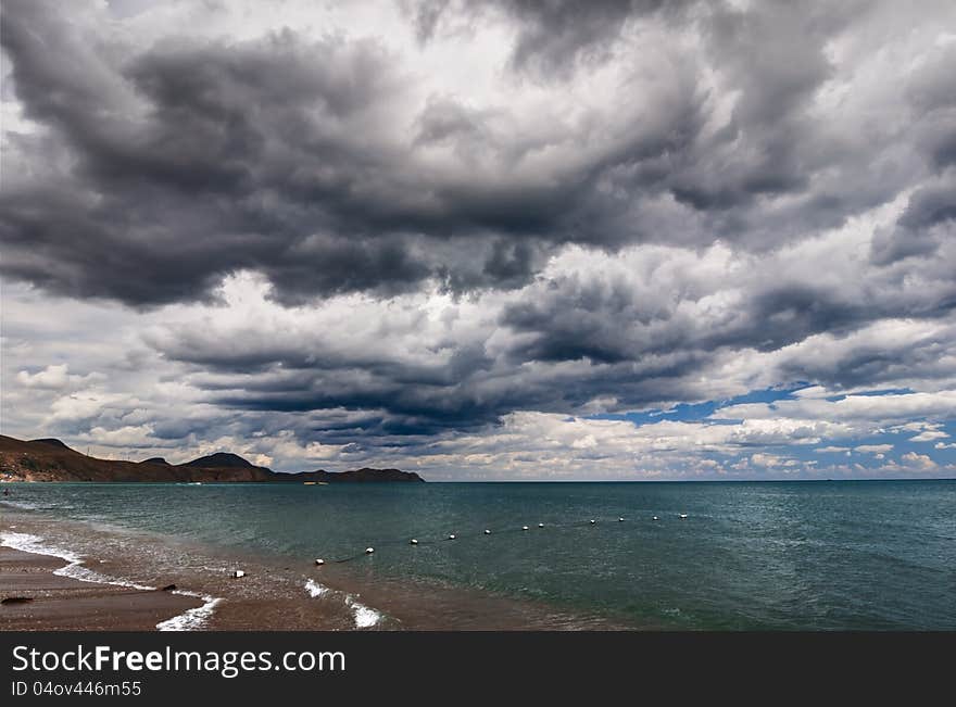 View of thunderstorm clouds above the sea. View of thunderstorm clouds above the sea