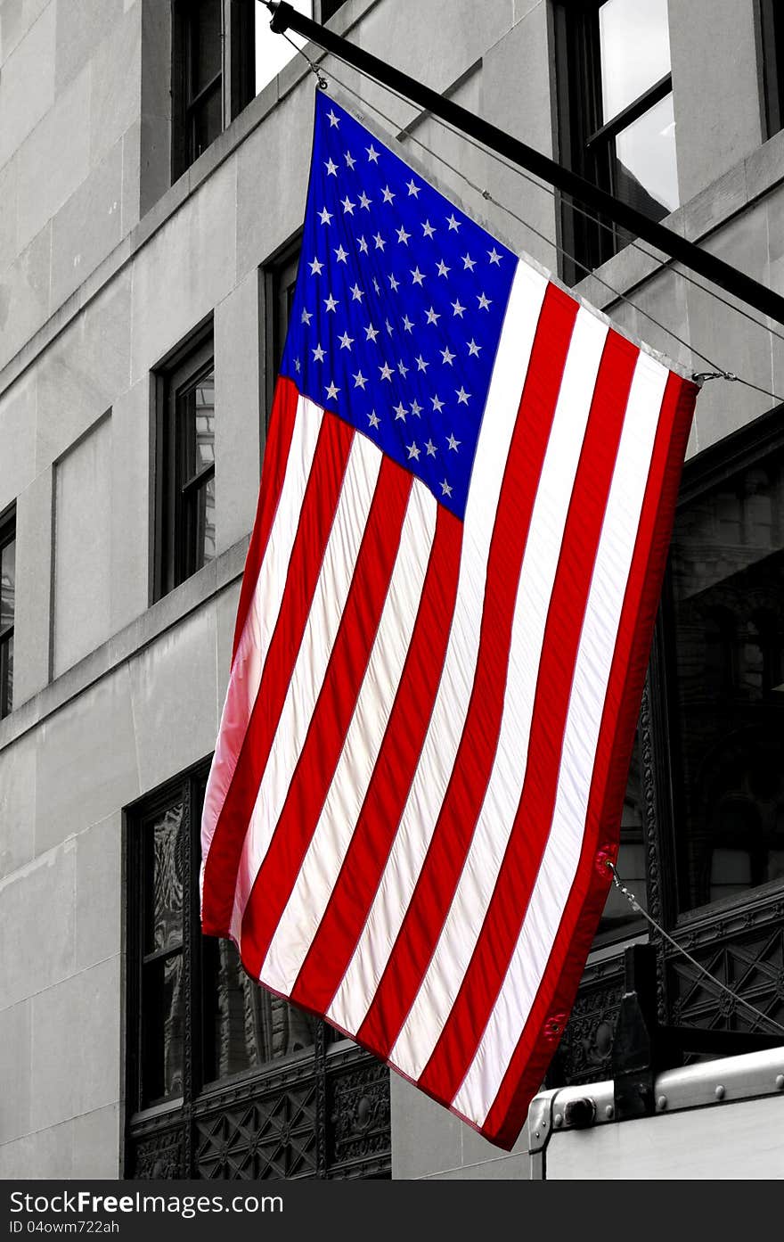 American flag with building in the background