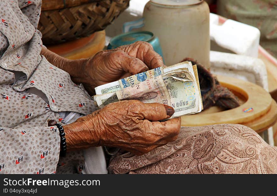 A Vietnamese old woman with money