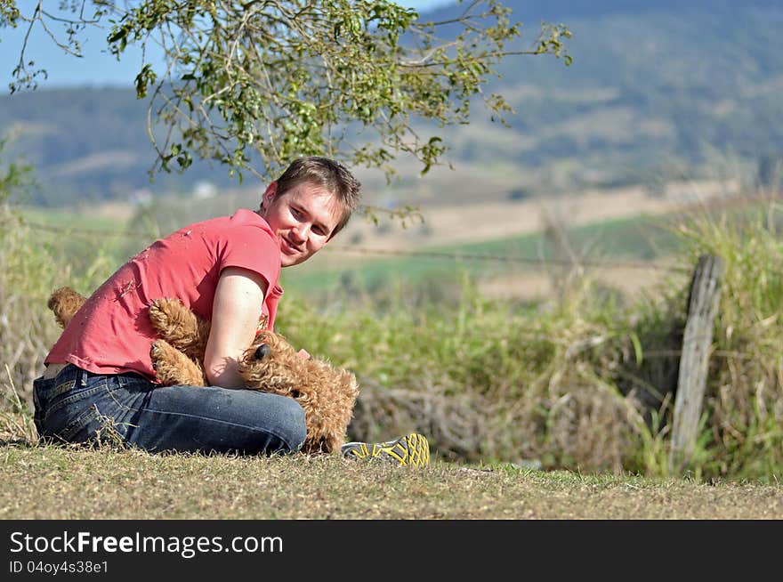 Young man relaxing and having fun playing with his best friend, his dog. Young man relaxing and having fun playing with his best friend, his dog.