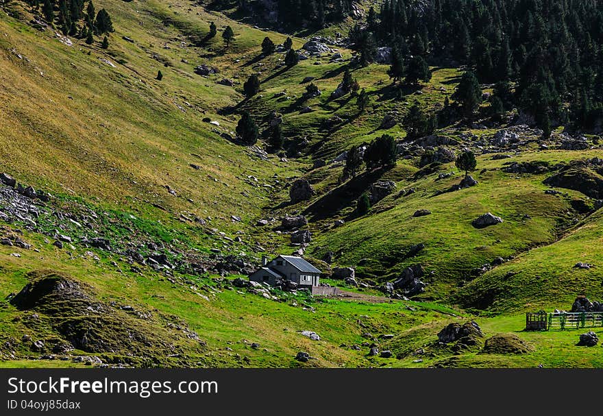 Image of a shelter located in a mountainous valley (Ossau Valley) in Pyrenees Mountains, France.