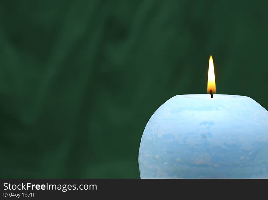 The blue candle, green background