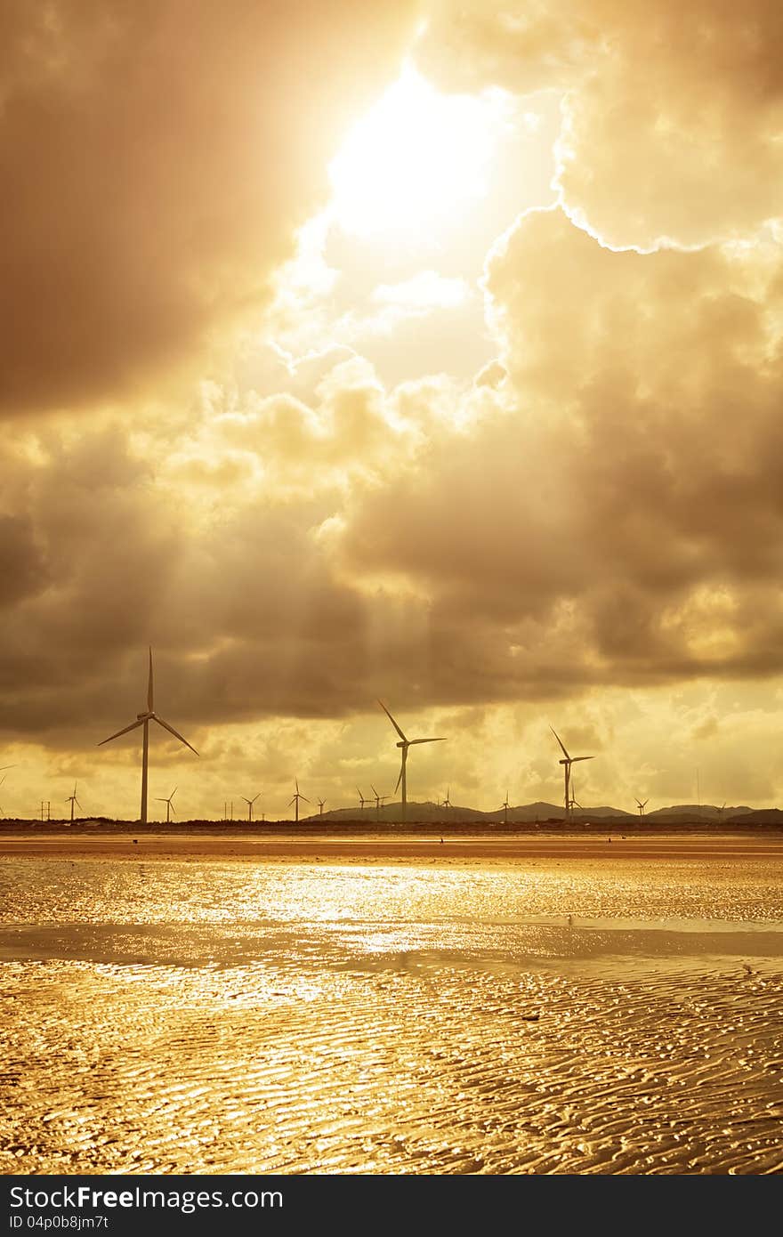 Group of Wind Power Installations in Sunset