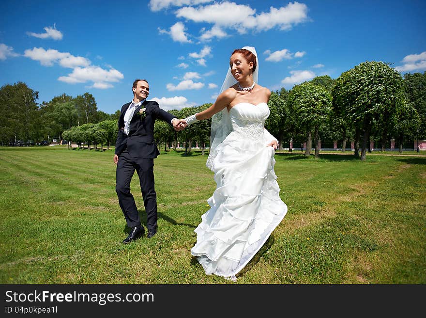 Happy groom and happy bride on wedding walk