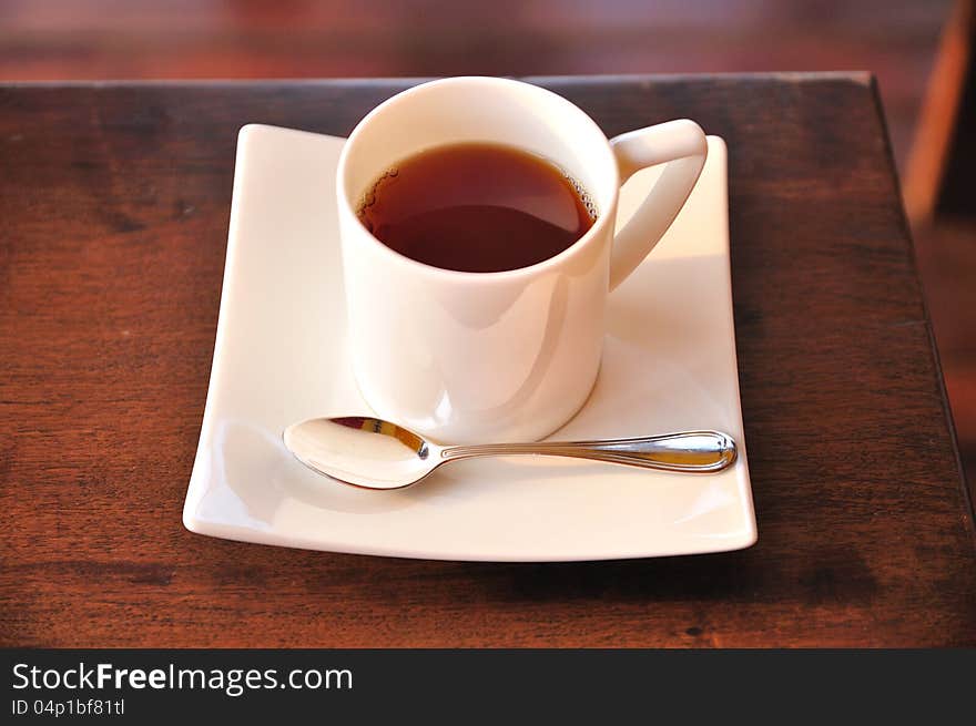 A cup of hot tea on table