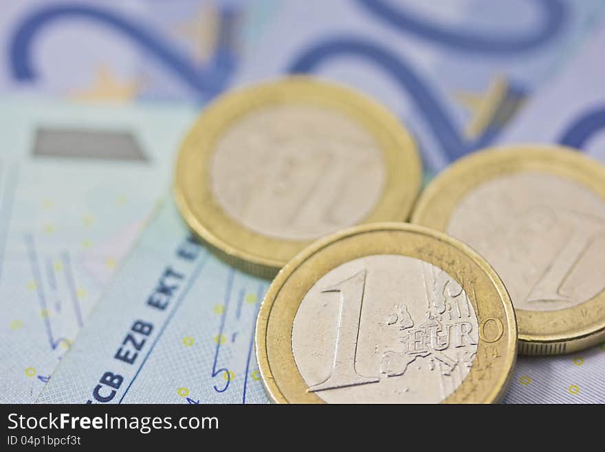 Detailed view of euro coins lying on paper money. Background. Detailed view of euro coins lying on paper money. Background.