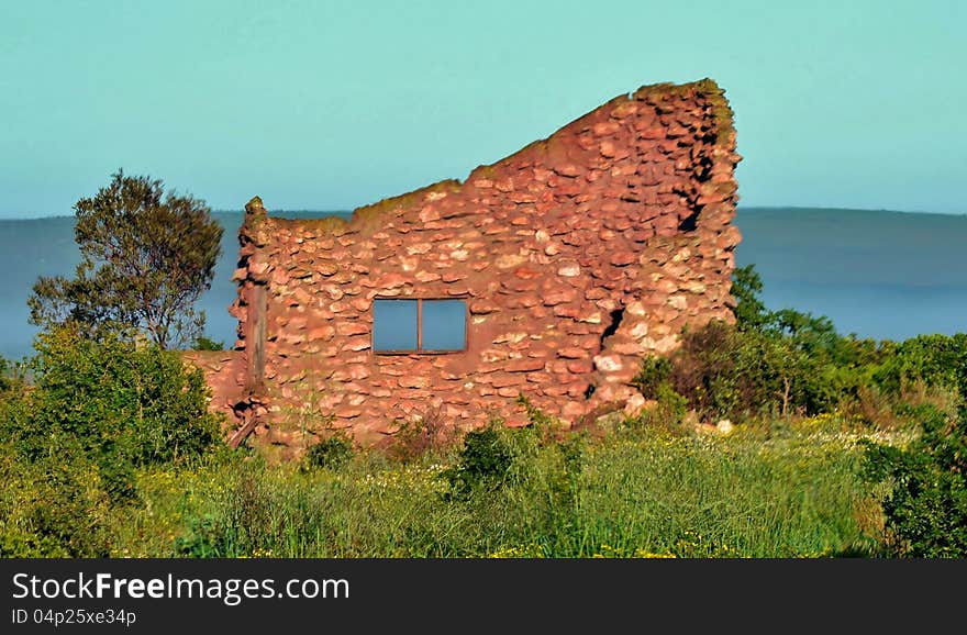 Landscape with ruin of a red stone farm house. Landscape with ruin of a red stone farm house