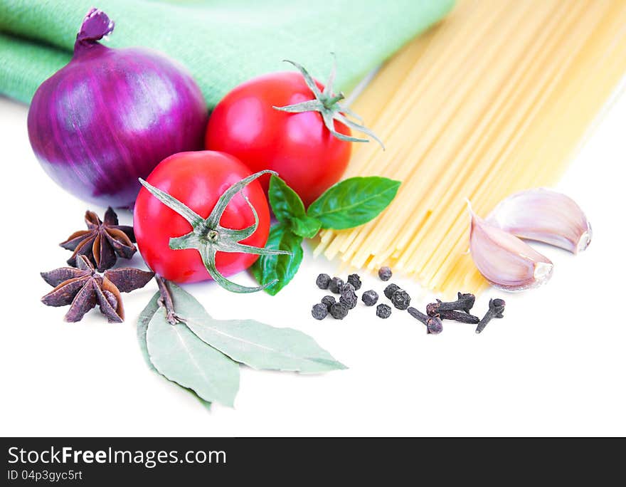 Pasta, spices and vegetables on a white background. Pasta, spices and vegetables on a white background