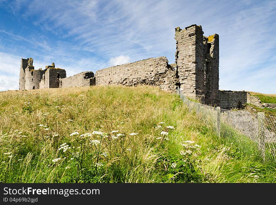 Iconic Dunstanburgh castle ruin built in the 14th century viewed from the south close up. Iconic Dunstanburgh castle ruin built in the 14th century viewed from the south close up