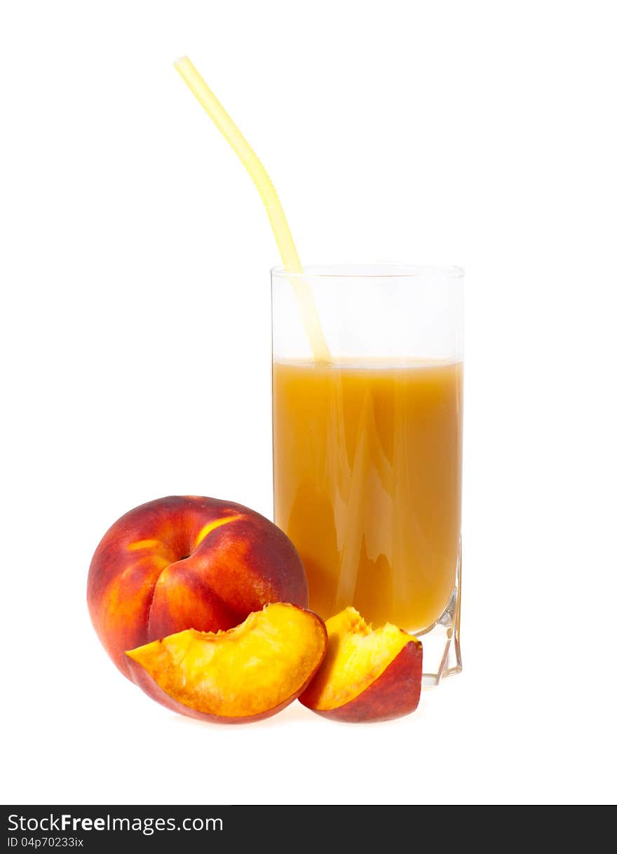 Peach juice in a glass nearby a peach from shares