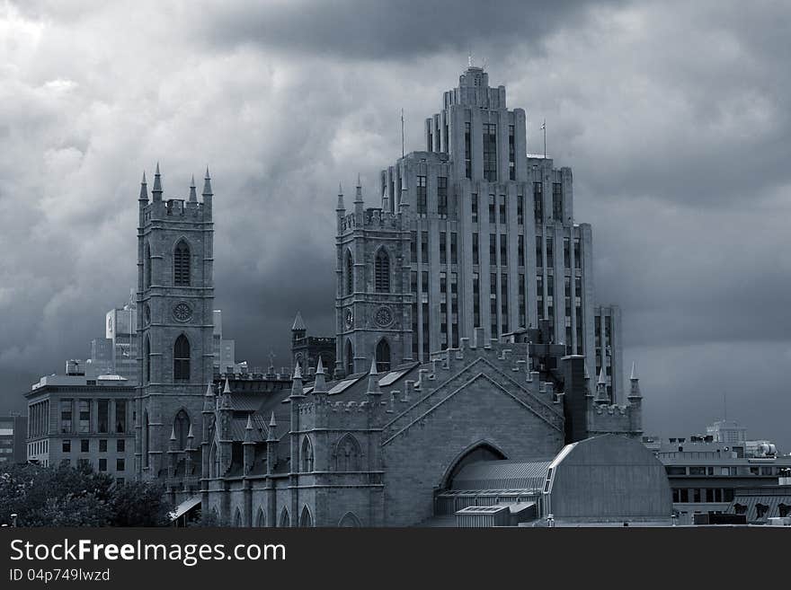 Moody monochrome image of Notre Dame Cathedral and other old buildings on a stormy cloudy background. Moody monochrome image of Notre Dame Cathedral and other old buildings on a stormy cloudy background.