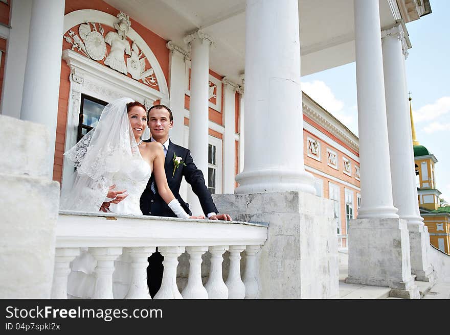 Happy bride and groom in ancient building