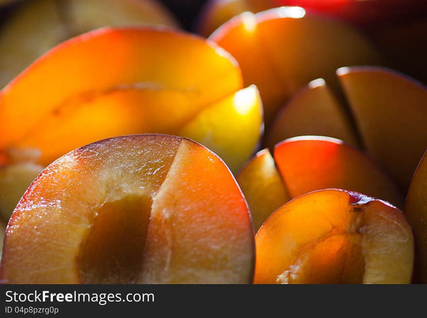 Halfs of plums are illuminated by the warm and late evening sun. Halfs of plums are illuminated by the warm and late evening sun