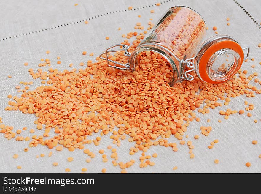 Red lentils on linen table napkin