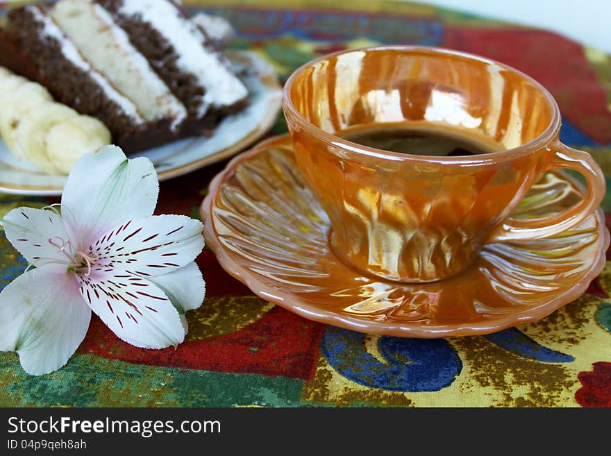 Cup of coffee with cake on colorful cloth. Cup of coffee with cake on colorful cloth