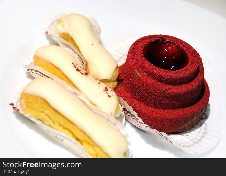 Cakes with cream, on a white plate