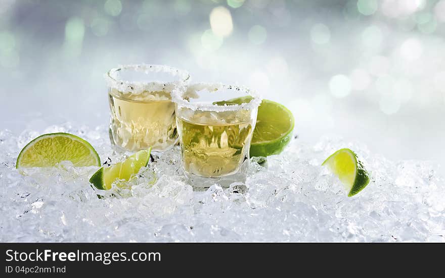 Gold tequila with salt and lime on a ice.