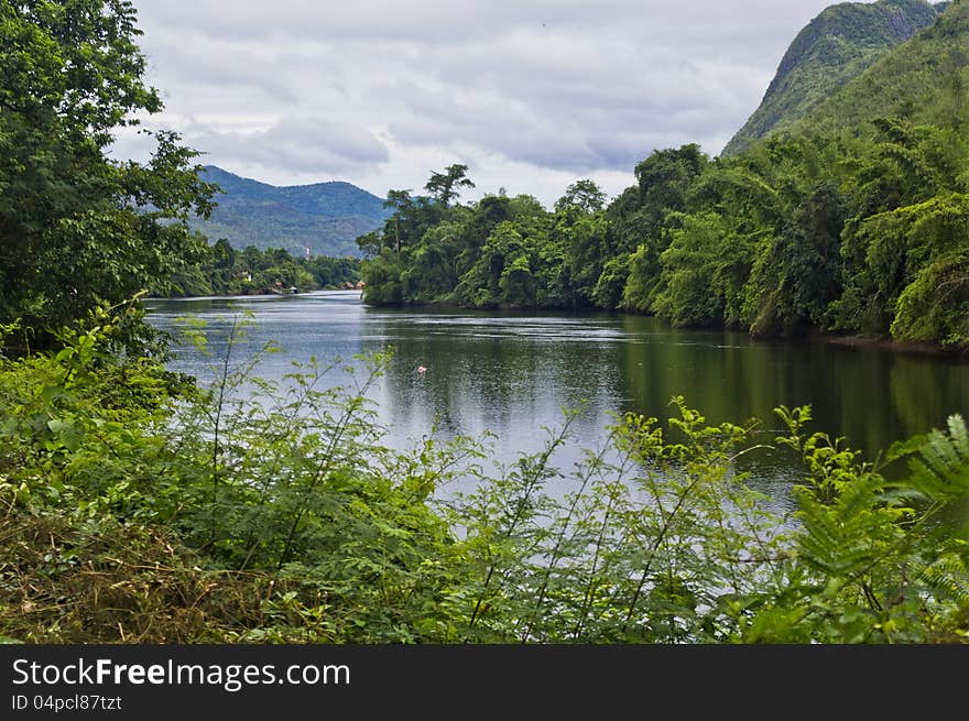 River Kwai in Kanchanaburi flowing through mountains