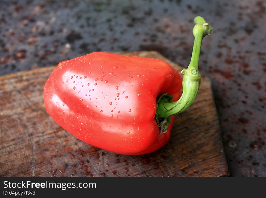 Red pepper on a wooden background close-up