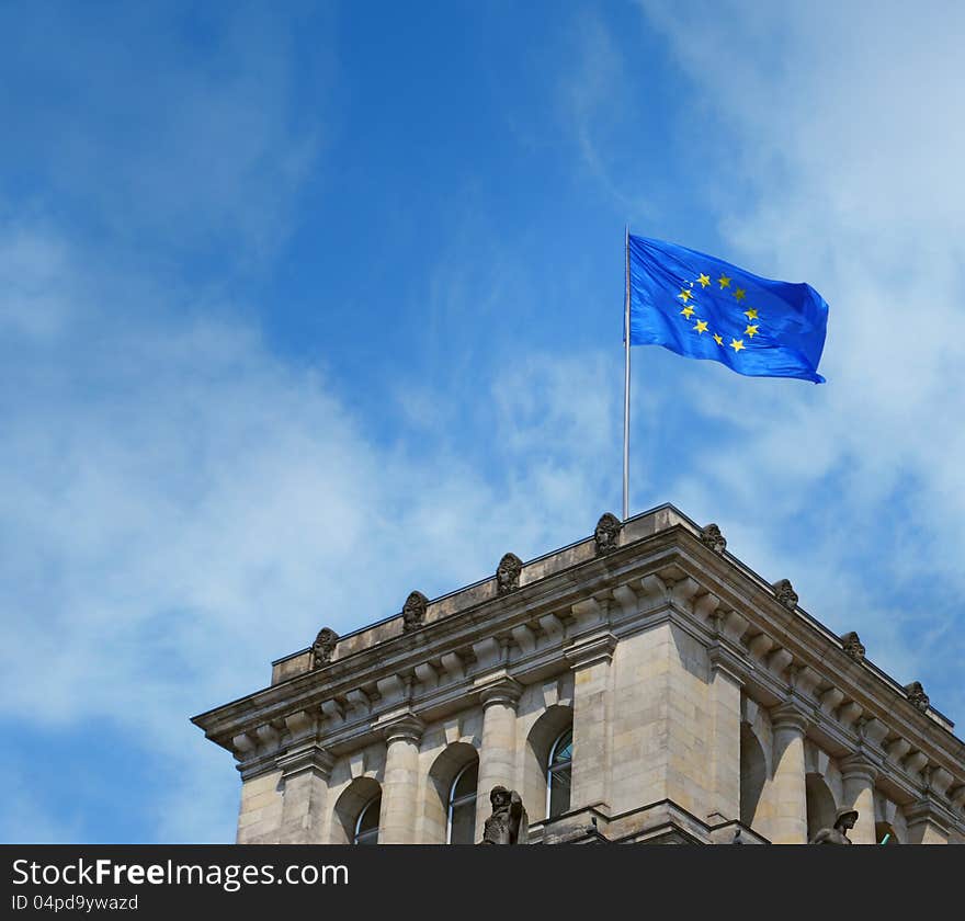 Europe flag on old european building flying on blue sky. Europe flag on old european building flying on blue sky