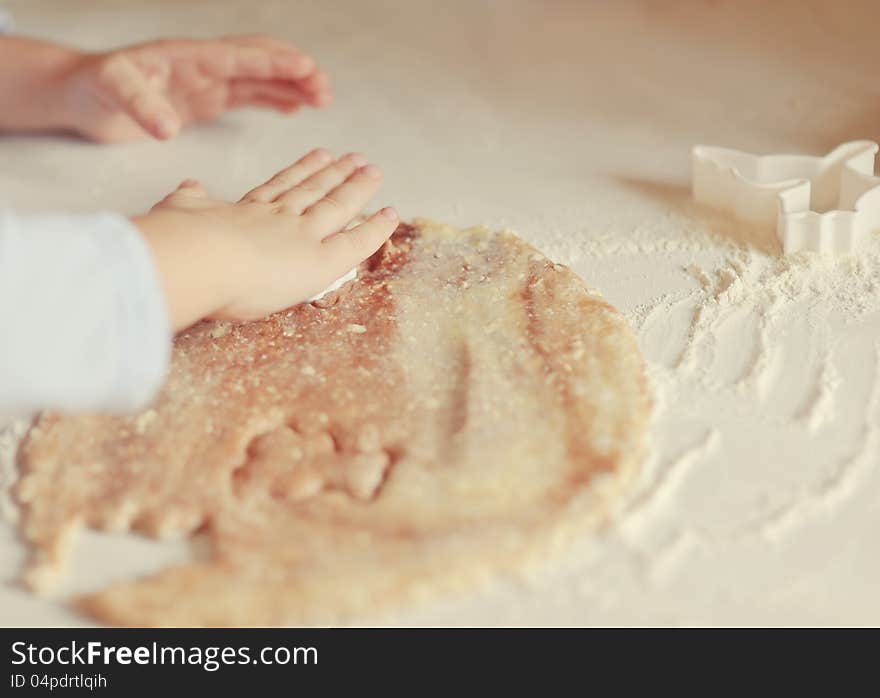 Children's hands make molds for pastry dough. Children's hands make molds for pastry dough