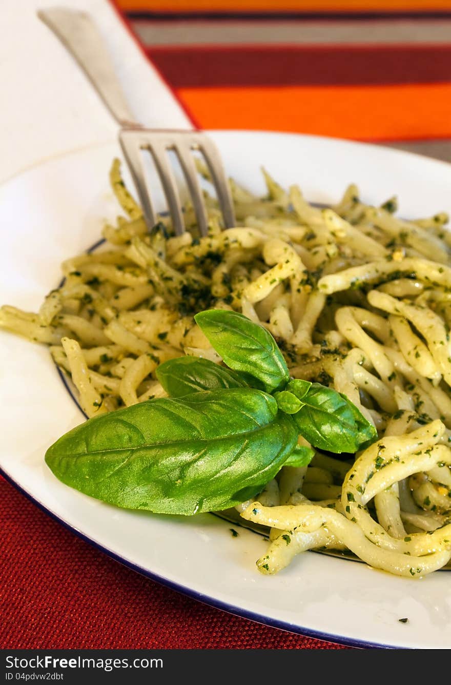 A plate of pasta with pesto