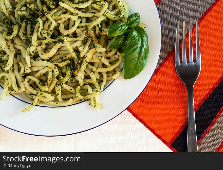 A plate of pasta with pesto