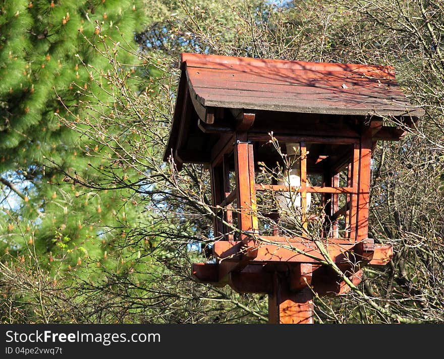 Beautiful wooden lamp in east style among trees in a city Japanese garden. Beautiful wooden lamp in east style among trees in a city Japanese garden