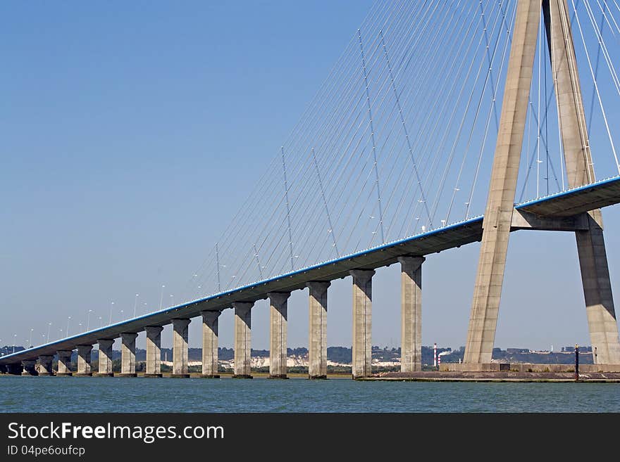 The famous Pont de Normandie spans the Seine river connecting Le Havre to Honfleur in Normandy.View from the side of Honfleur. The famous Pont de Normandie spans the Seine river connecting Le Havre to Honfleur in Normandy.View from the side of Honfleur.