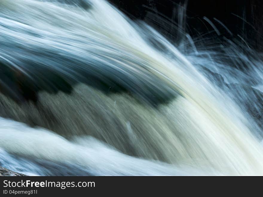 Fluid water texture in mountains river with splashes, outdoors. Fluid water texture in mountains river with splashes, outdoors