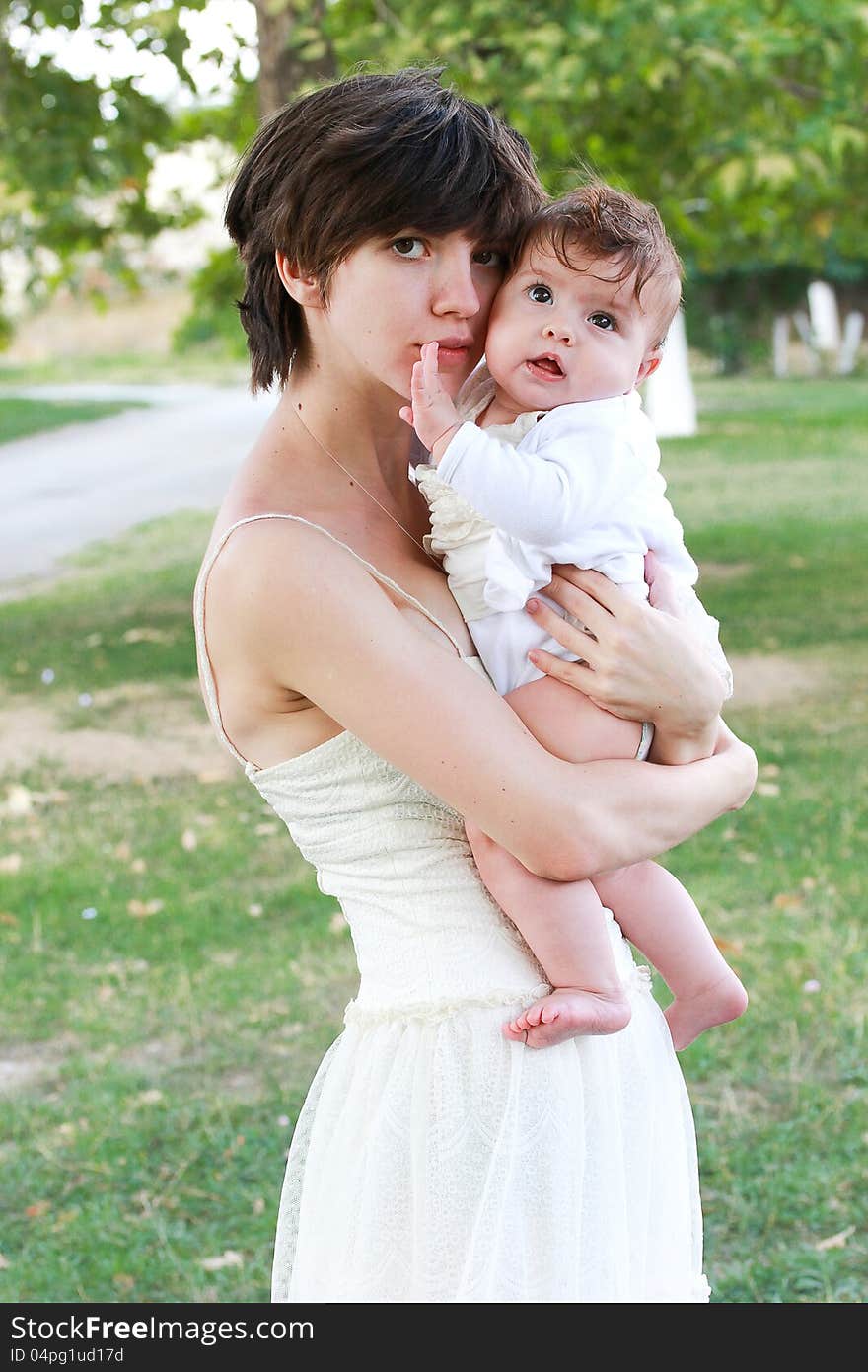 Mother holding her little beautiful daughter. Mother holding her little beautiful daughter