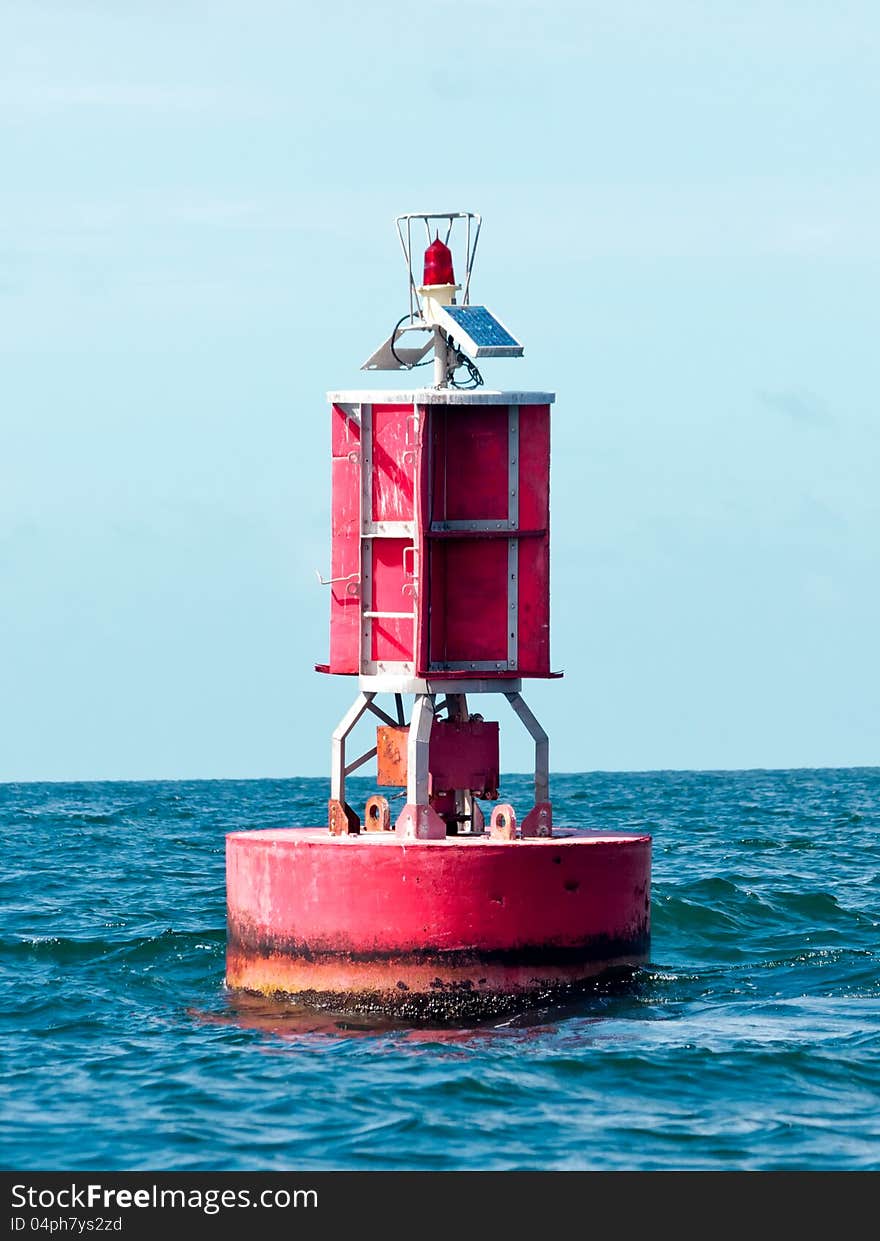 Floating red buoy at mid of sea for aware tsunami in Thailand