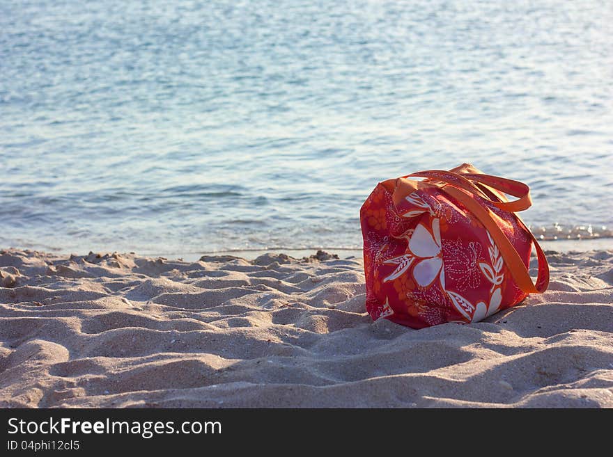 Summer beach bag on sandy beach. Summer beach bag on sandy beach