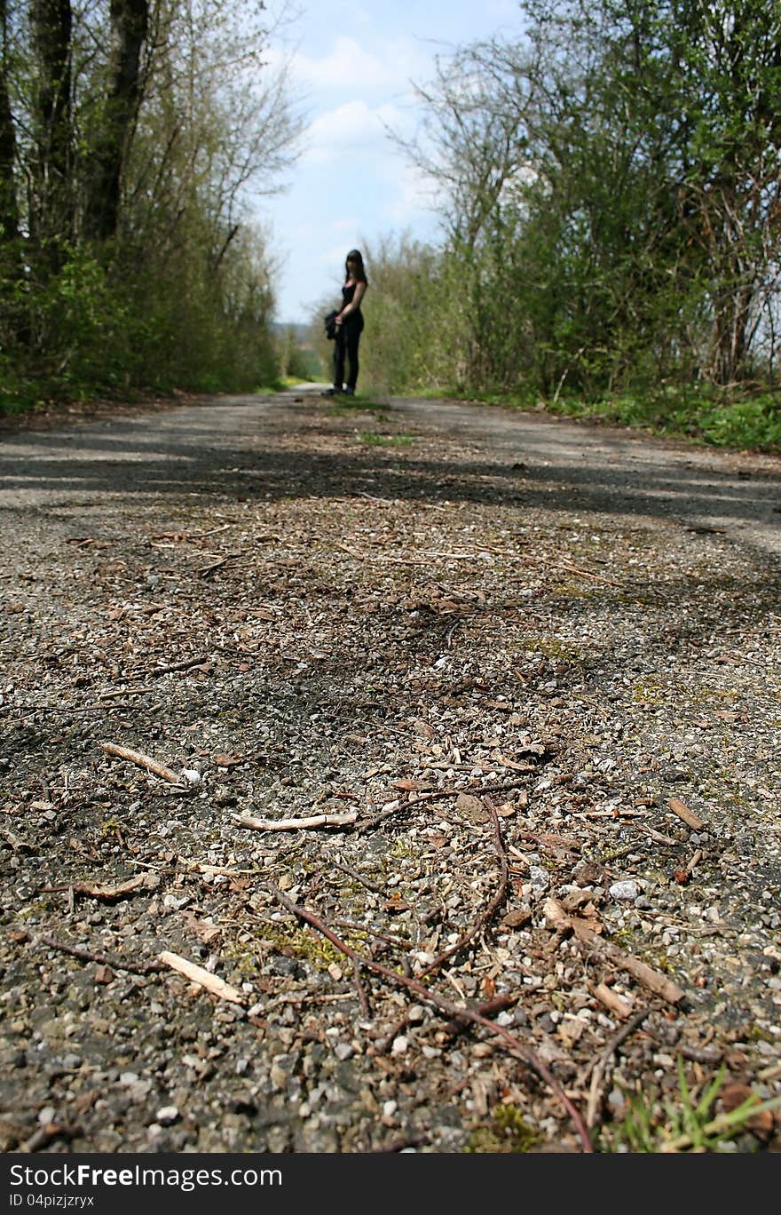 Lonesome away - a sad girl stands lonely on a street