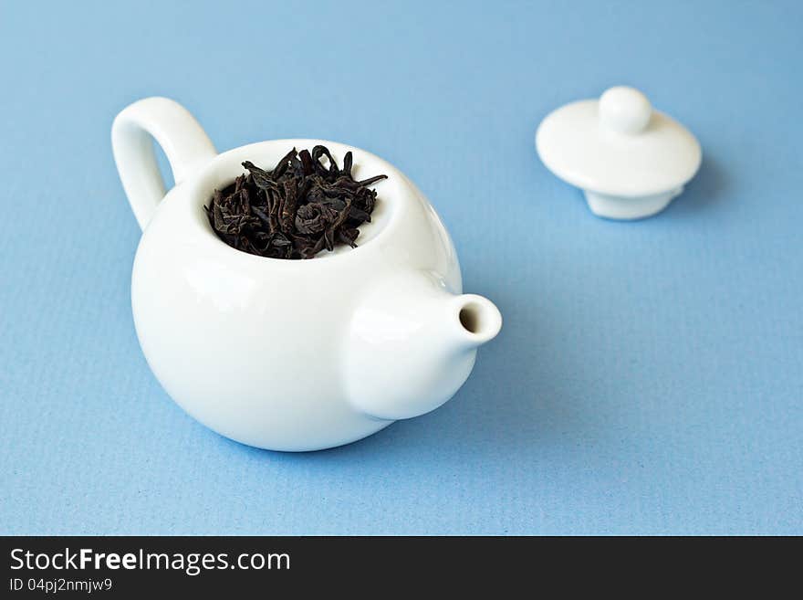 Small Tea Pot With Leaves Of Black Tea